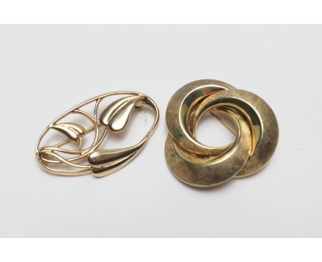 14ct gold eternal knot brooch, with textured finish, 30mm, weight approx. 8.7g; also a 9ct gold openwork leaf brooch in the A