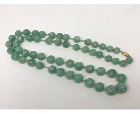 A Chinese apple green jade beaded necklace
