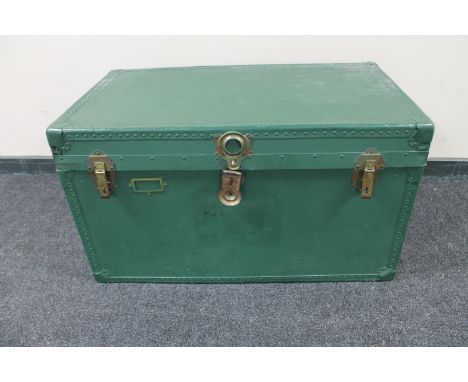 An early 20th century painted metal bound shipping trunk  