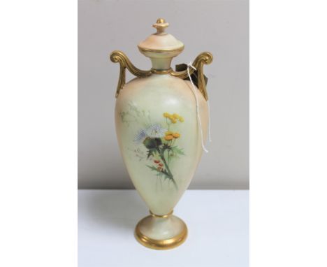 A Royal Worcester blush ivory hand painted lidded urn with gilded handles, height 23.5 cm