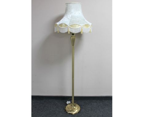 A contemporary brass standard lamp with shade 