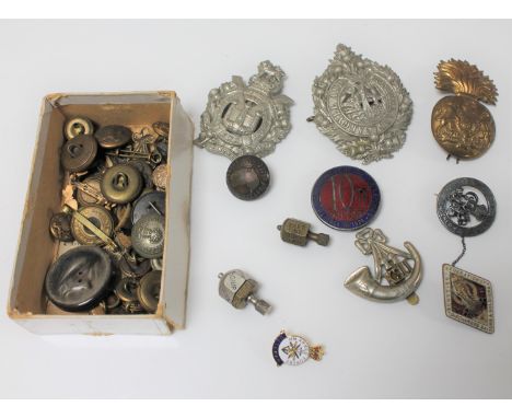 A box of military badges and buttons, trench art spinning tops etc 