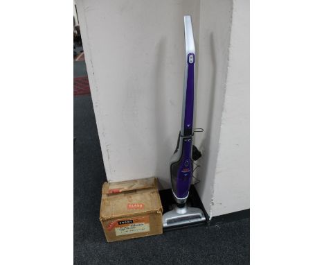 A Vax Dynamo Power cordless vacuum and a boxed magazine slide projector 