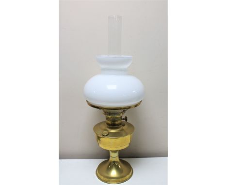 An antique brass Aladdin oil lamp with glass shade and chimney 