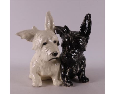 A black and white earthenware Scottish Terrier puppies, Germany, Sitzendorf, 1970s, h 23 cm.