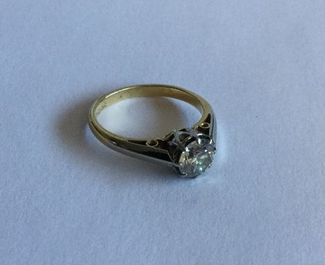 A diamond single stone ring in two colour 18 carat gold claw mount. Approx. 3 grams. Est. £100 - £200.