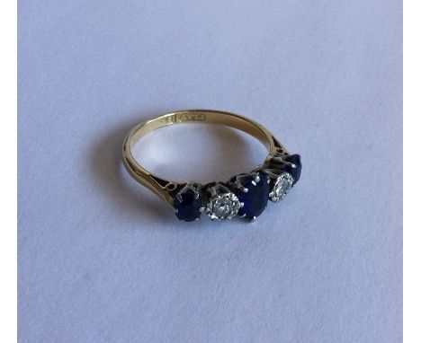 A good sapphire and diamond five stone half hoop ring in 18 carat two colour gold. Approx. 2 grams. Est. £80 - £120.