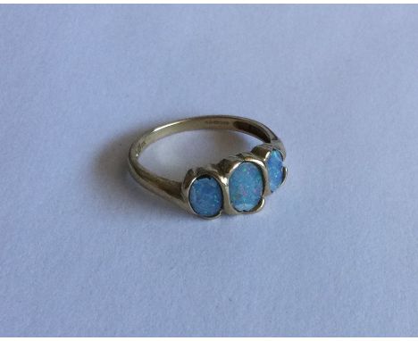 An opal three stone ring in 9 carat mount. Approx. 2 grams. Est. £30 - £50.