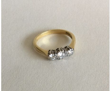 A good diamond three stone ring in two colour gold setting. Approx. 3 grams. Est. £100 - £200.