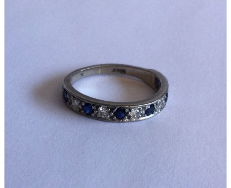 A sapphire and diamond eleven stone half eternity ring in 18 carat gold setting. Approx. 4 grams. Est. £80 - £120.