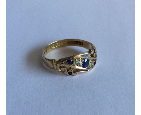 An 18 carat gold sapphire and diamond five stone boat shaped ring. Approx. 2 grams. Est. £40 - £60.