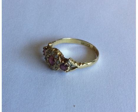 A ruby and diamond cluster ring in 18 carat mount. Approx. 4 grams. Est. £50 - £80.