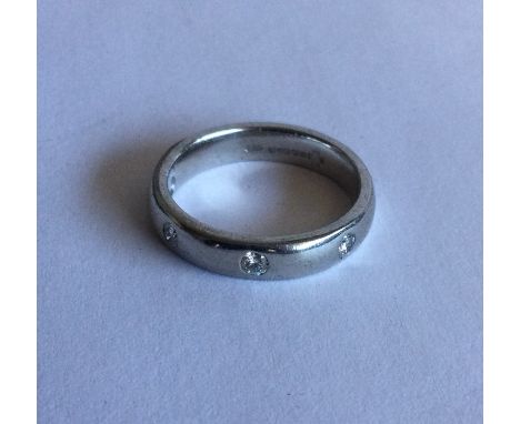 A good diamond four stone half eternity ring in heavy 18 carat white gold rubover mount. Approx. 6 grams. Est. £100 - £200.