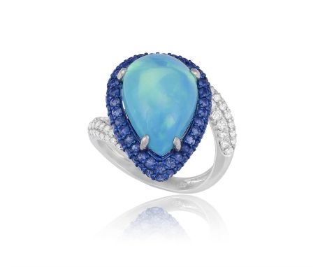 An Opal, sapphire and diamond ringThe cabochon-cut, pear-shaped black opal within a round, mixed-cut sapphire surround, the s