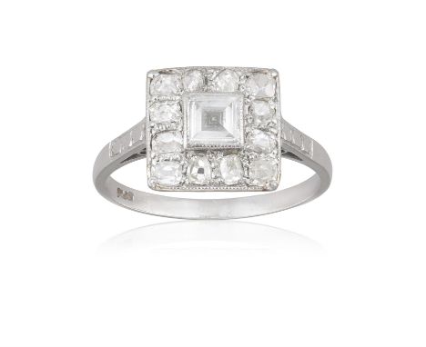 A Diamond dress ringThe ring centrally set with a square, step-cut diamond, within a pavé-set single and old-cut diamond surr