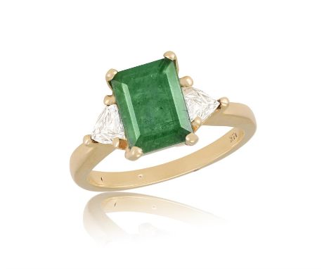 An Emerald and diamond three-stone ringThe emerald-cut emerald flanked by two trillion-cut diamonds, claw-set and mounted in 