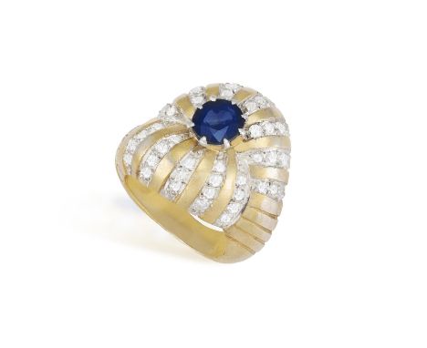 A Sapphire and diamond ring, French, circa 1950Of bombé design, the centrally set oval-shaped sapphire with rays of single-cu