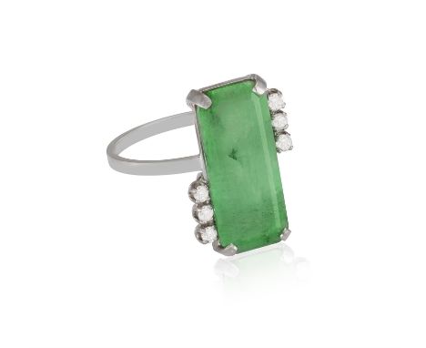 An Emerald and diamond ringThe emerald-cut emerald, flanked on both sides by three single-cut diamonds, estimated emerald wei