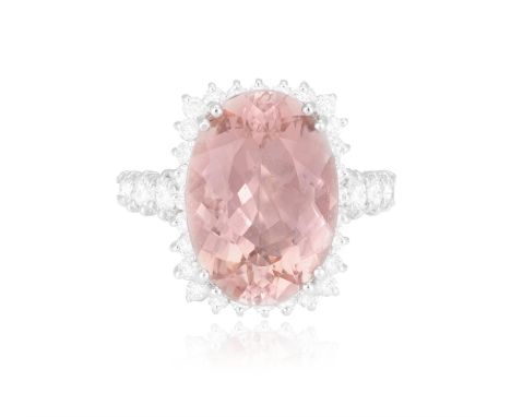 A Morganite and diamond cluster ringThe oval, mixed-cut morganite, bordered by round, brilliant-cut diamonds, mounted in 14ct