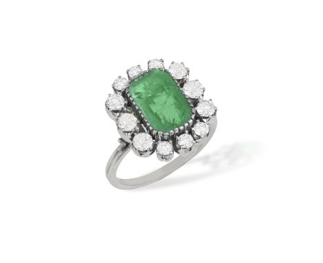 An Emerald and diamond cluster ringThe rectangular-cut emerald within an old European-cut diamond surround, in claw setting, 