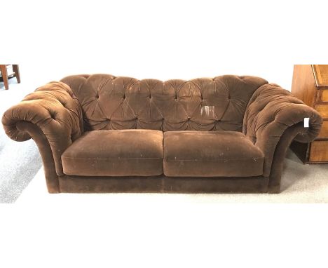 Three seat sofa, shaped cresting rail, scrolling arms, upholstered in a chocolate fabric - Condition Report 