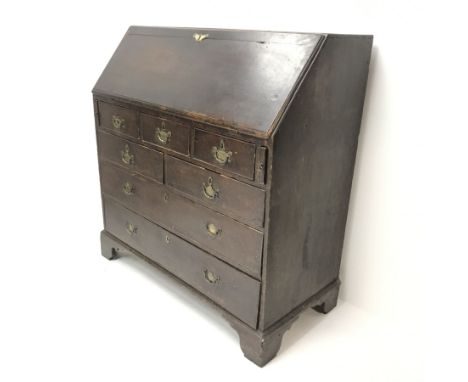 19th century oak bureau, fall front enclosing fitted interior above seven graduating drawers, ogee bracket supports, W104cm, 