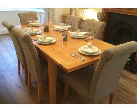 Light oak extending dining table, two leaves, square tapering supports and six Very roll top high back chairs upholstered in 