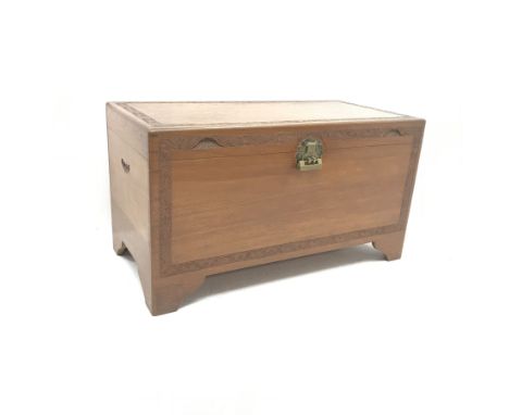 Early 20th century camphor wood chest, single hinged lid with carved foliage detailing, ogee bracket supports, W102cm, H56cm,