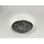 A Japanese cloisonne enamel dish in kyotojippo style, Meiji period, the central roundel depicting