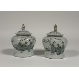 A pair of Chinese famille rose porcelain baluster jars and covers, c. 1900, each painted to the