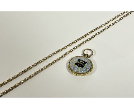 A late Victorian yellow metal (unmarked) and enamel mourning locket on chain, the circular hinged locket decorated to the fro