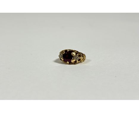 A ruby and diamond three-stone ring, the central cushion-cut ruby flanked by a pair of round brilliant-cut diamonds, on openw