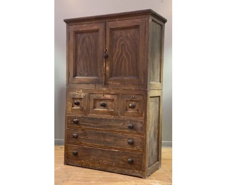 A 19th century Scottish scumbled pine press or housekeeper's cupboard, the twin panelled doors opening to a painted interior 