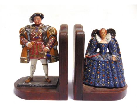 [SECOND WORLD WAR INTEREST]. A PAIR OF HAND-PAINTED CAST METAL &amp; POLISHED OAK BOOK ENDS  modelled as Henry VIII and Eliza