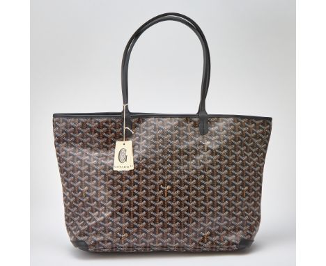 Printed canvas tote with black leather dual top handles and silver-tone zipper pull. Unlined white canvas interior with one s