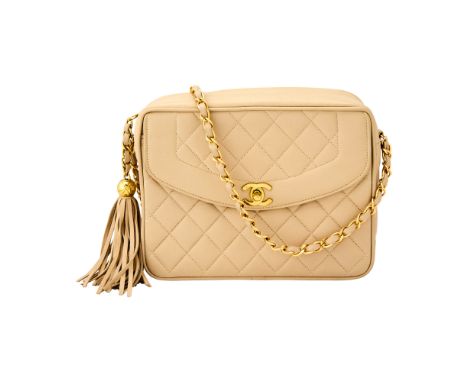 Zip top bag with gold-tone hardware and tassle zipper pull, front pocket with double 'CC' turn lock closure and woven-in leat