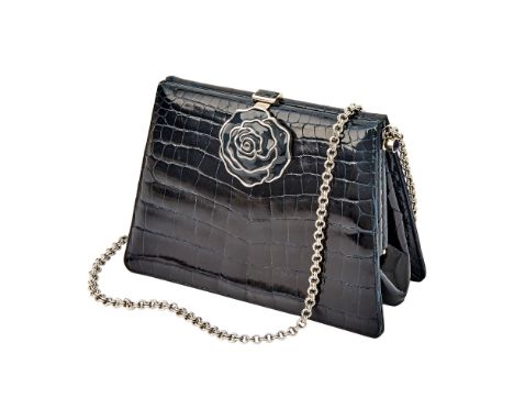 Dark midnight blue crocodile with silver-tone hardware, chain strap and enamel flower clasp. Matching leather interior with s