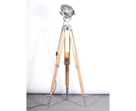 A Strand Electric theatre spot light, on tripod adjustable stand, chrome mounts, height 180cm.