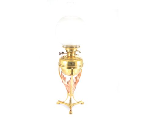W.A.S. Benson, an Art Nouveau brass and copper oil lamp, the removable brass reservoir supported on tripod base, with applied