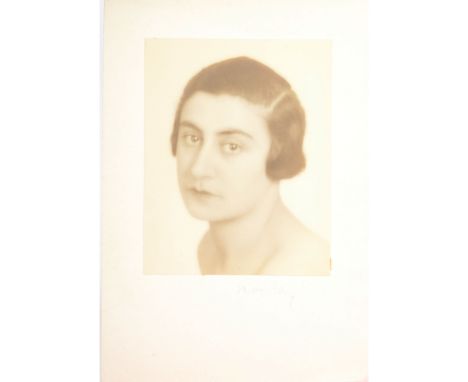 Man Raya portrait photograph, 1930ssigned in pencil to the mount stamped verso 'Man Ray 31 bis, Rue Campagne-Premiere, Paris'