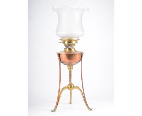 W.A.S. Benson, an Art Nouveau brass and copper oil lamp, fitted with a Hinks &amp; Sons Patent taper housing, the copper rese