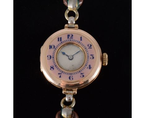A lady's vintage gold wrist watch with enamel bezel, the 25mm 9 carat rose gold case having a pink enamel bezel with blue Ara