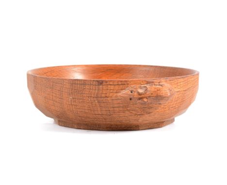 Robert 'Mouseman' Thompson of Kilburn, an oak nut bowl, adzed exterior, carved mouse signature, 15.5cm diameter.