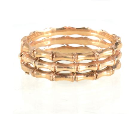 A 9 carat yellow gold half hinged bangle, triple hoop bamboo design, 18mm wide, hallmarked Birmingham 1994, approximate weigh
