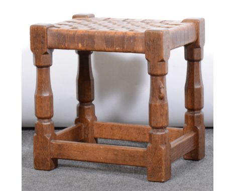 Robert 'Mouseman' Thompson of Kilburn, an oak stool with woven leather seat, octagonal supports, carved signature mouse, widt