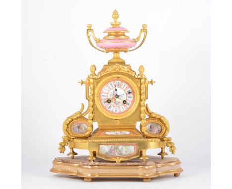 A Louis XV style gilt metal and Rose Pompadour porcelain mantel clock, 19th Century, urn finial, casing cast with floral pend