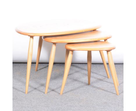 Ercol, a nest of three 'Pebble' tables, shape 354, elm and birch, gold and brown label, width 65cm, depth 45cm, height 40cm. 