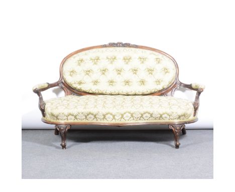 Victorian walnut sofa, upholstered buttoned and patterned brocade, oval back with cartouche and scroll cresting, open arms, s