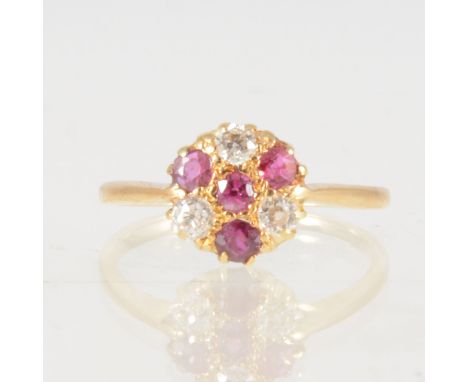 A ruby and diamond circular cluster ring, four rubies and three old cut diamonds claw set in an all yellow gold mount, cluste