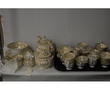 A white and gilt Rockingham style tea set for twelve people, to include: tea cups, coffee cups, teapot, saucers, and others.